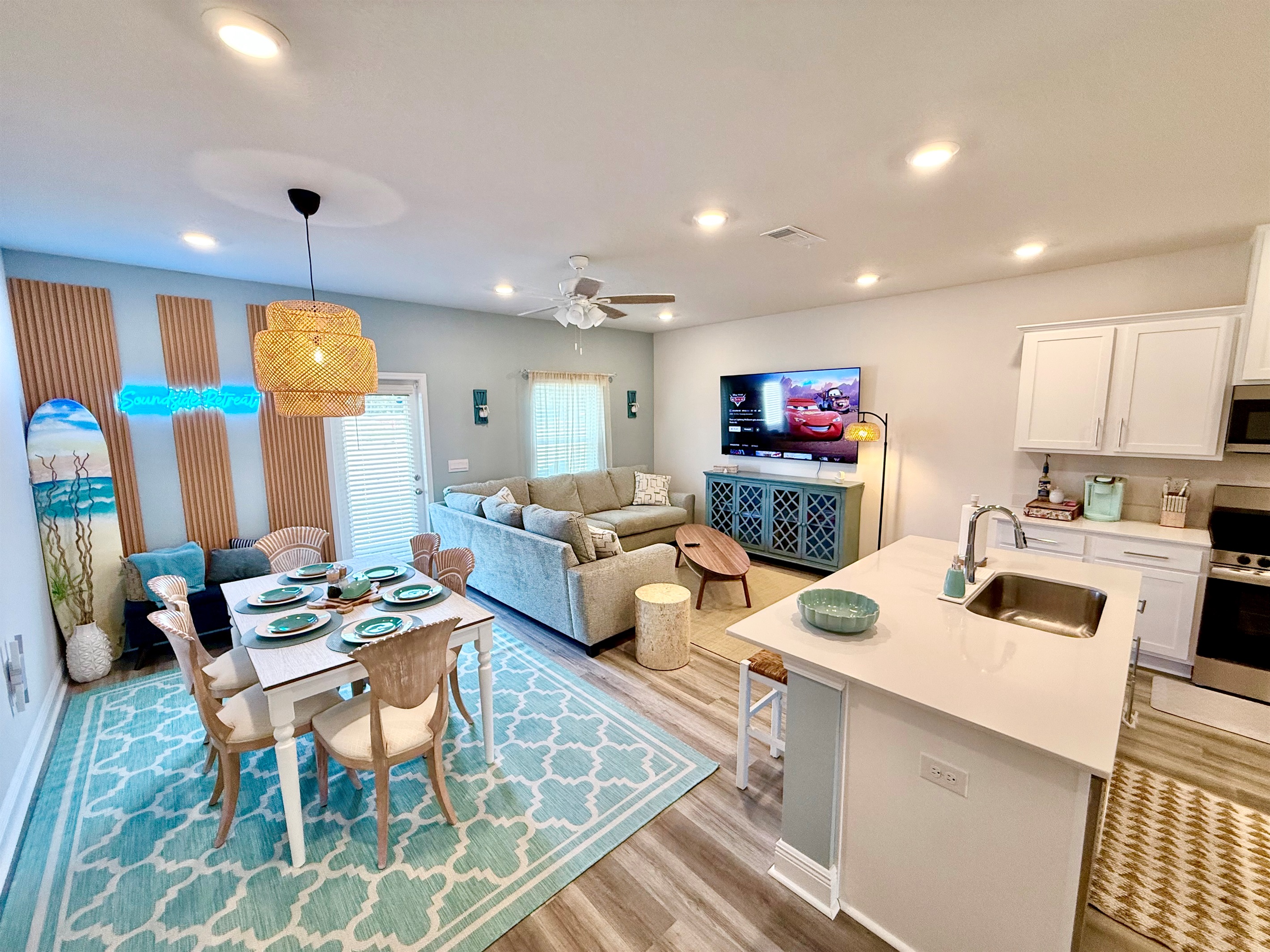 The open & spacious floor plan in the living room features dining are for six, premium furniture, and a huge 70" 4K HDR Smart TV. Don't forget your streaming creds!