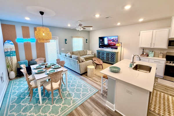The open & spacious floor plan in the living room features dining are for six, premium furniture, and a huge 70" 4K HDR Smart TV. Don't forget your streaming creds!