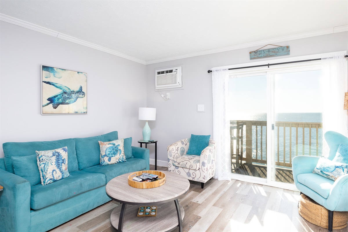 Cozy seating and a sliding window offering ocean views.