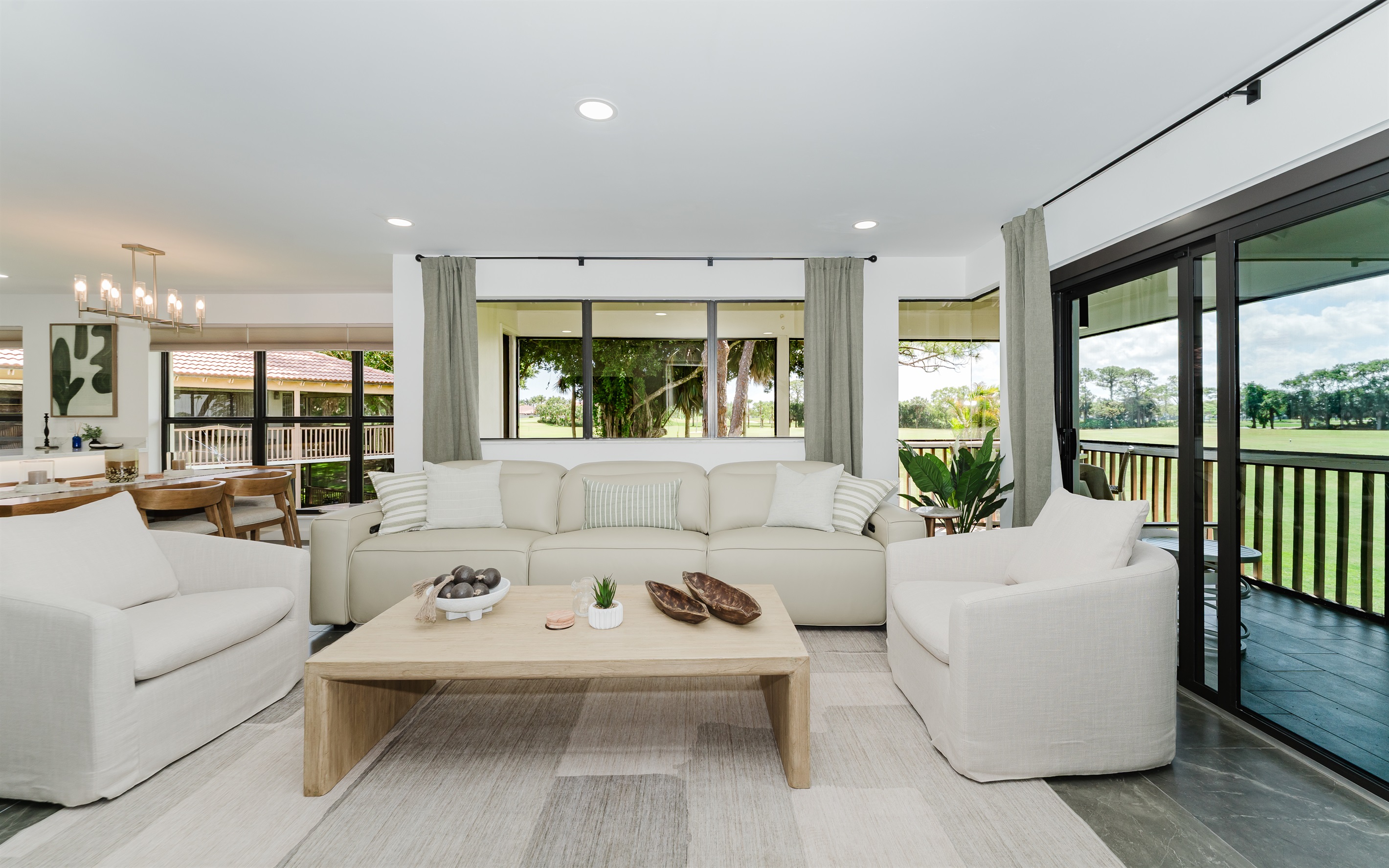 Bright, open living space filled with natural light and golf course views. Comfortable seating perfect for relaxing after a day at the beach or golf. Spacious living area designed for both comfort and style
Seamless indoor-outdoor feel with large windows.