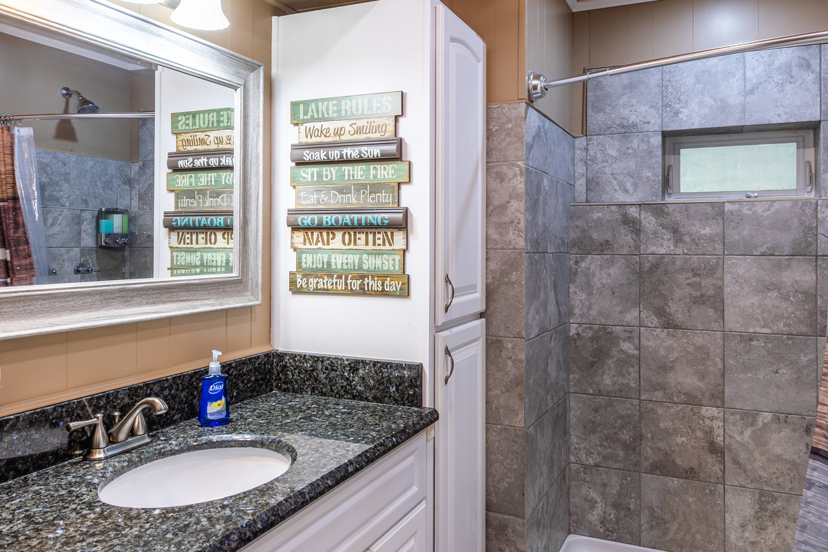 The full bathroom includes a walk-in shower, vanity storage, and the everyday essentials your family needs for an easy stay.
