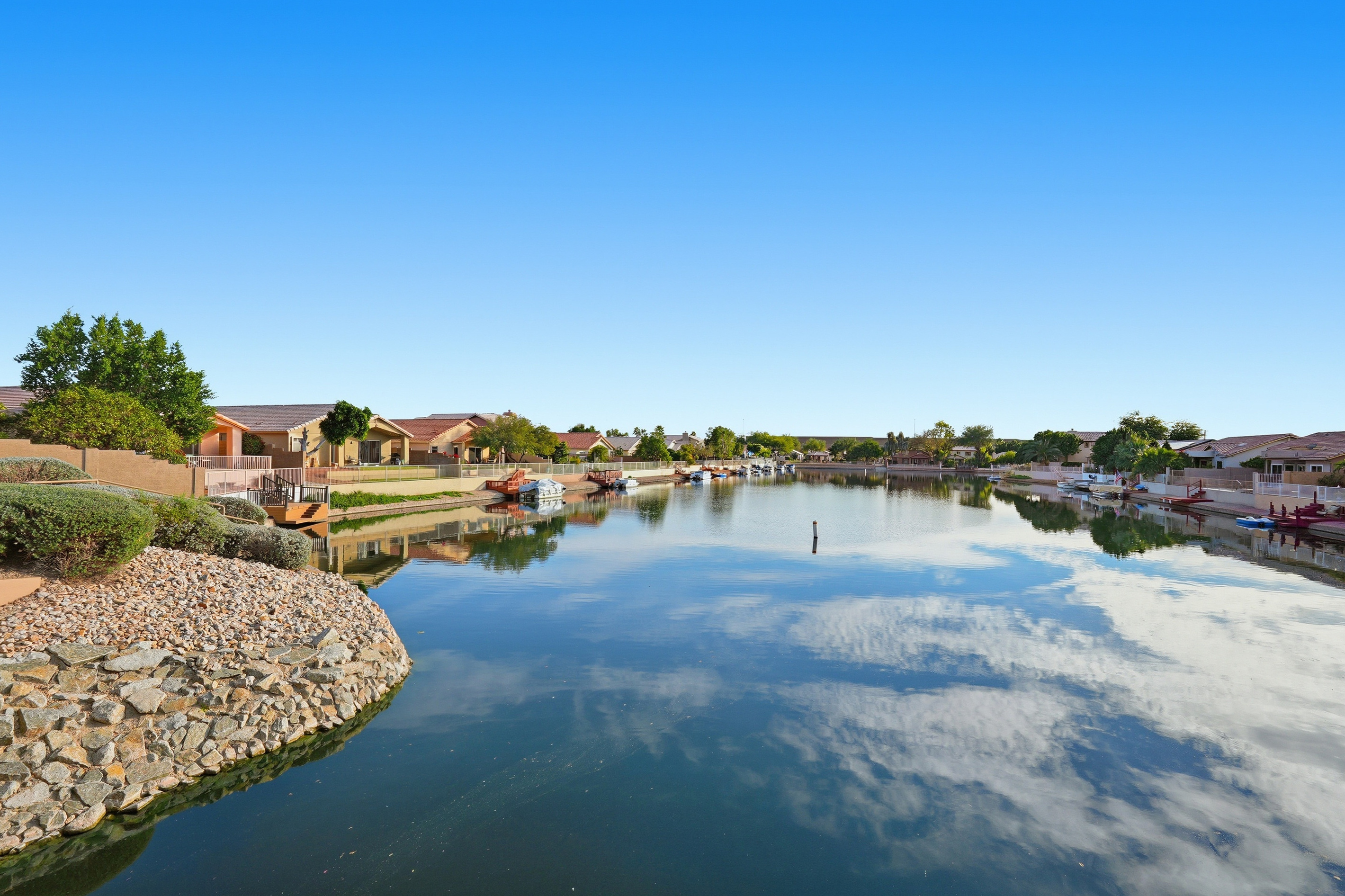 Arrowhead Lakes views with calm water, mountain backdrop, and scenic neighborhood surroundings nearby.