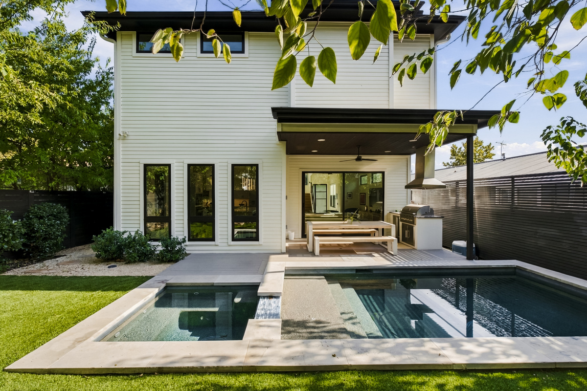 Private pool and spa framed by turf and modern outdoor living space.