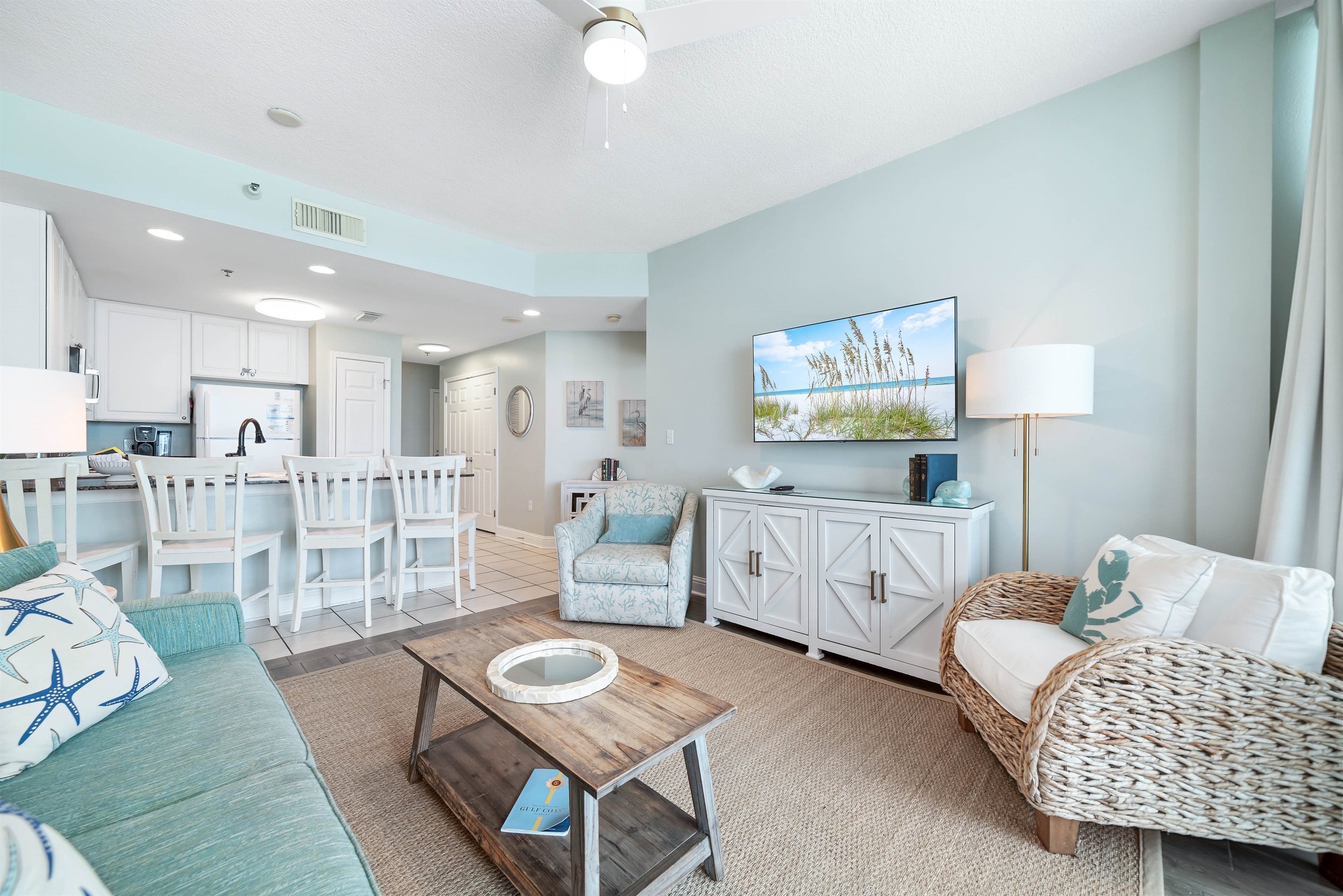 Light and airy living space featuring coastal-inspired decor and a seamless flow between the living and dining areas.