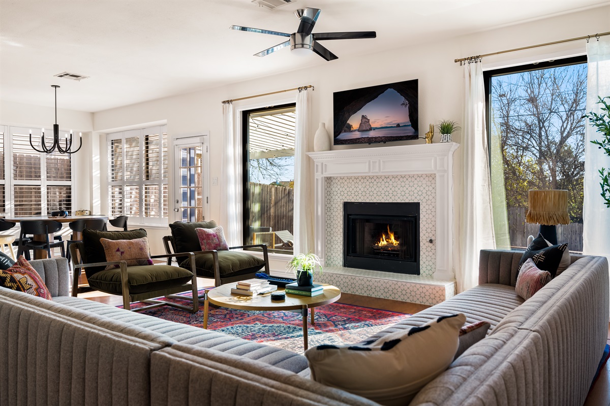 Luxurious lounge area featuring ample seating and a comforting fireplace glow