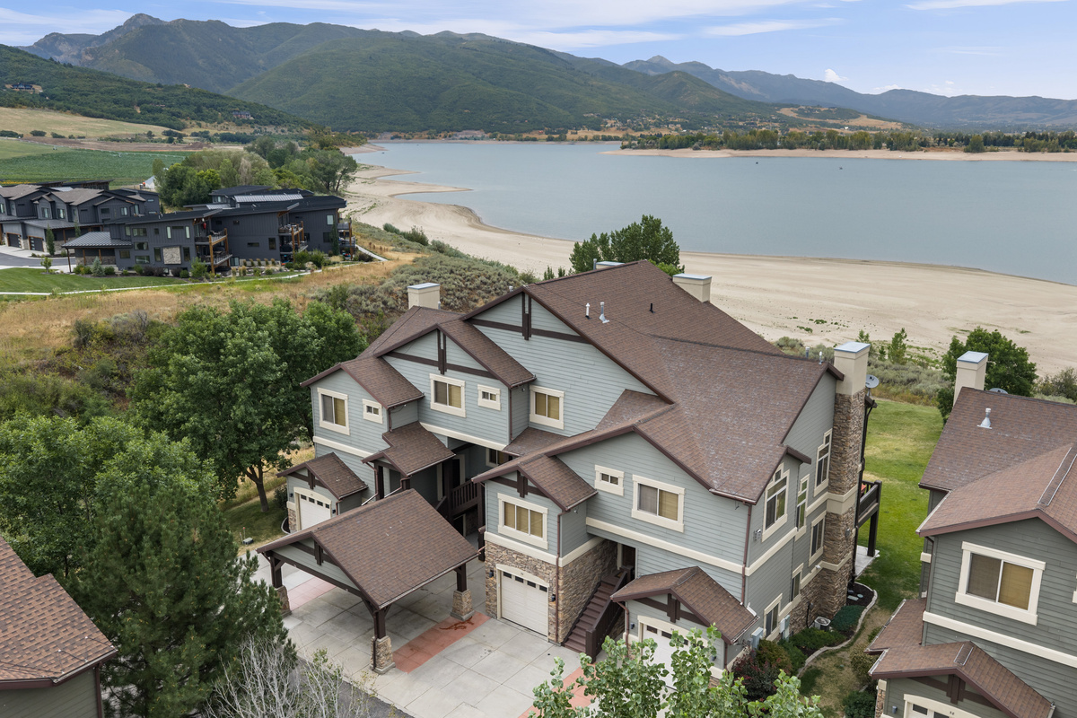Welcoming exterior of this Lakeside Village townhome with convenient garage and covered parking.