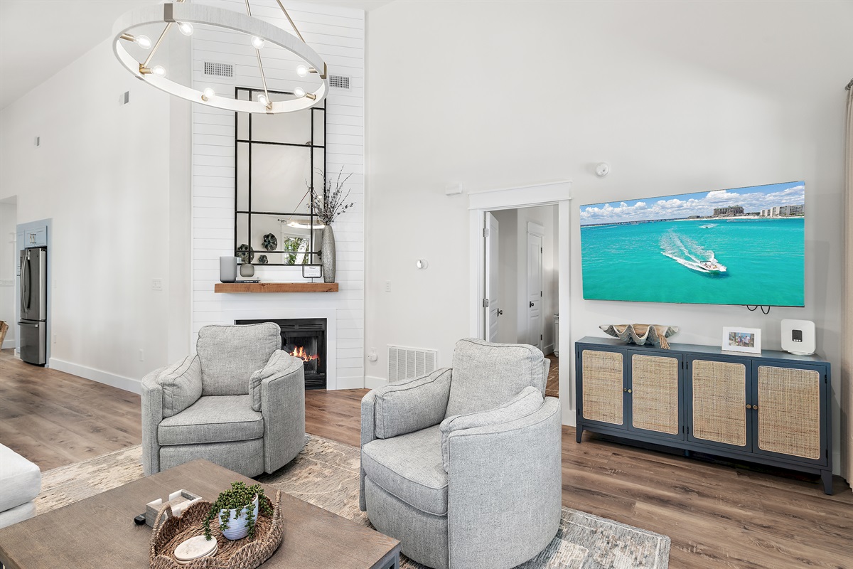 Cozy living area with large TV and natural light