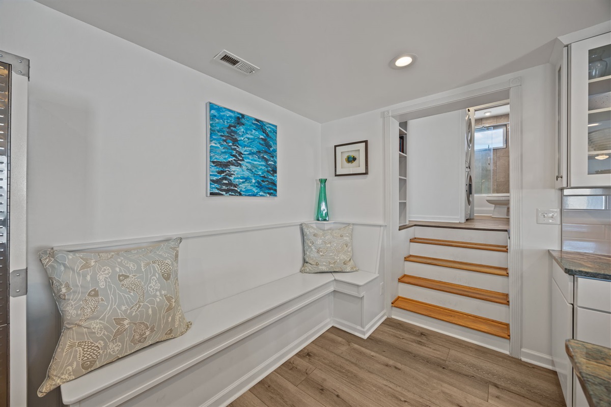 Cozy built-in bench with coastal art and soft seating