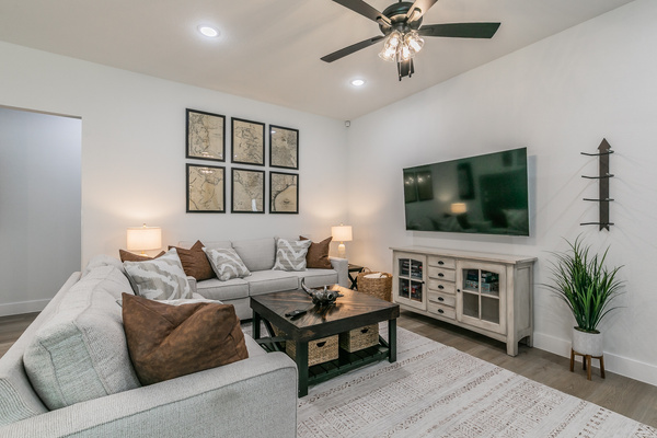 Western-themed living area with comfortable couches, chairs, and smart TV