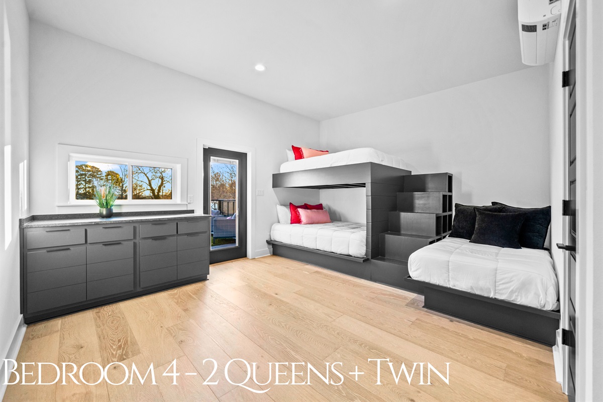 A spacious and stylish bunk room with two queen beds and a twin, offering flexible sleeping options and plenty of room for guests to feel at home.