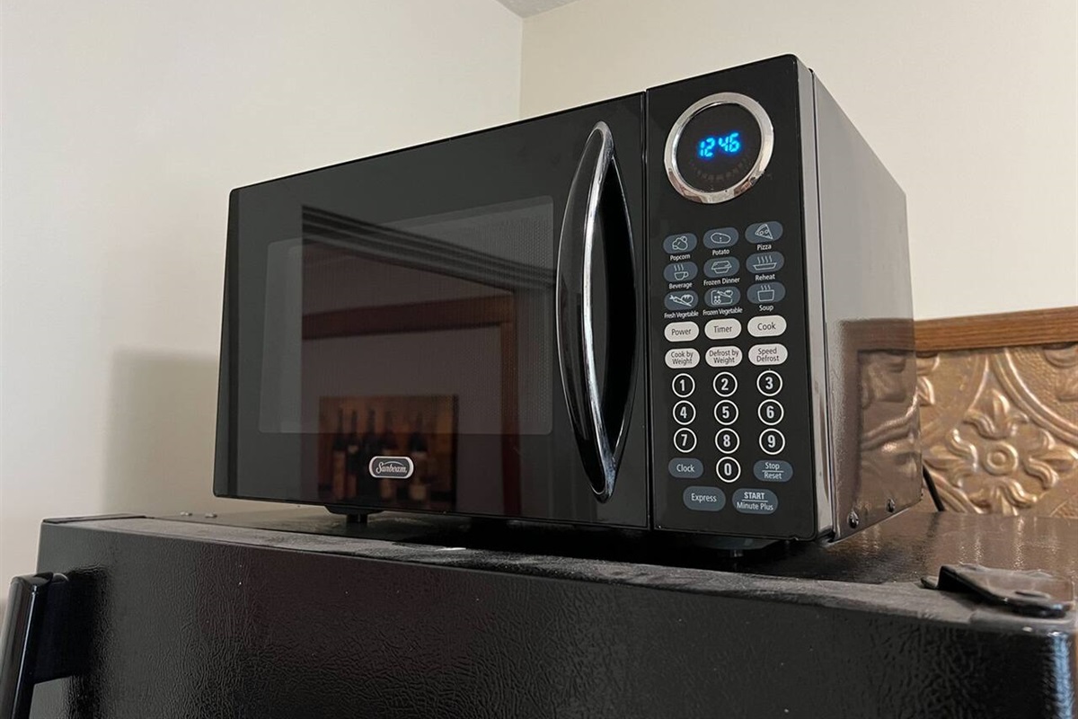Modern full kitchen featuring a sleek digital microwave, perfect for quick meals and reheating. Designed with style and convenience in mind, this kitchen space combines functionality with contemporary elegance