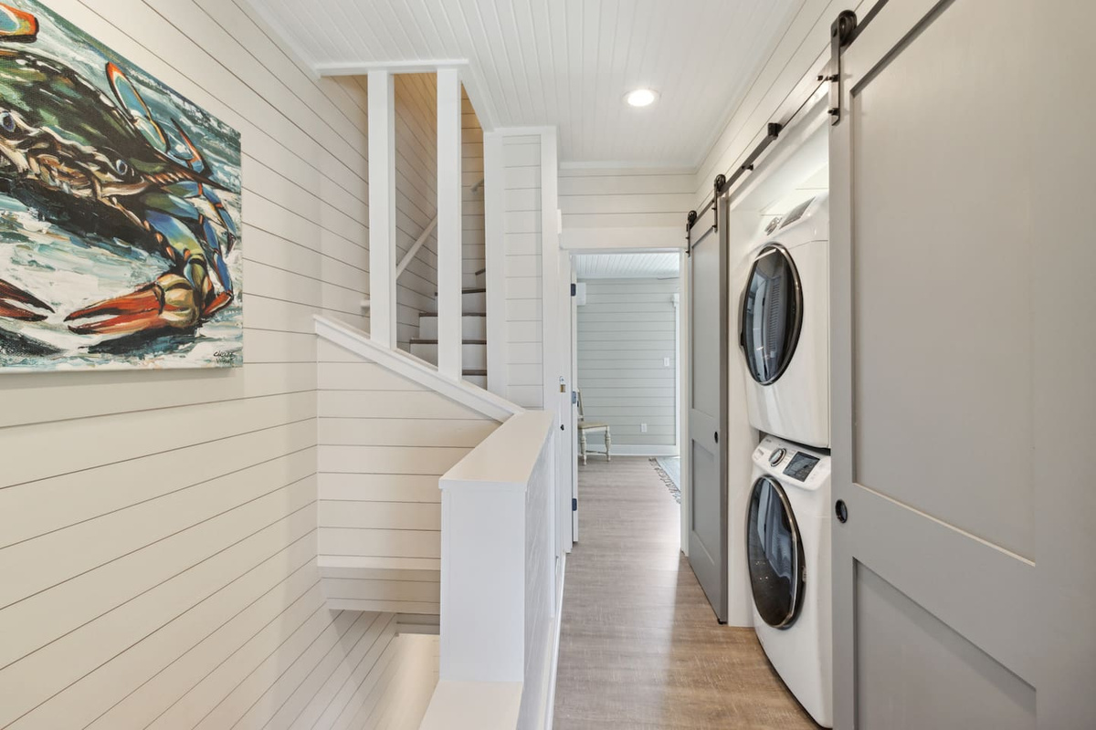 Full-size stacked washer and dryer in the hallway &mdash; pack lighter, you've got laundry sorted for the week.