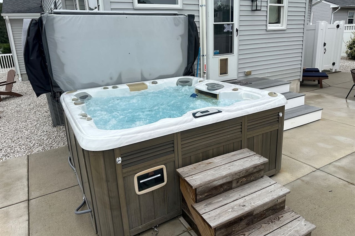 Unwind in this premium private hot tub, perfectly situated in the fenced backyard. With easy-access steps and multi-colored lighting, it offers the ultimate way to relax after a day at the beach.