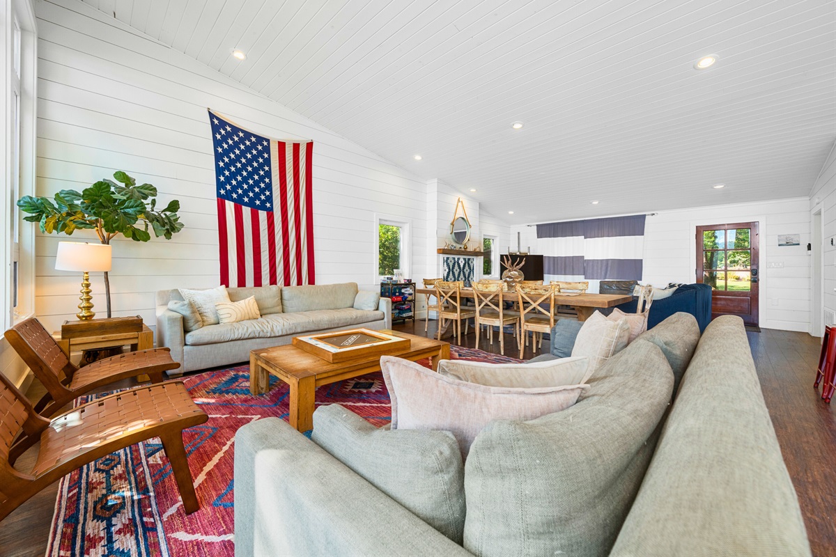 Spacious living area with vibrant rugs, big couches, and patriotic flair.