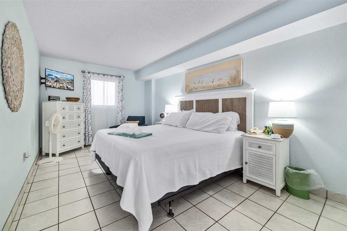 Wake up refreshed in a serene king suite — ideal for couples or quiet afternoon naps after the beach.