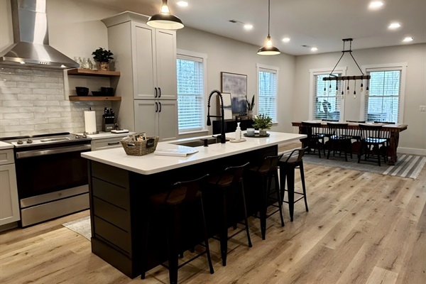 Experience culinary delight in our stunning open chef’s kitchen, complete with modern appliances, spacious island seating, and a warm, inviting atmosphere. 