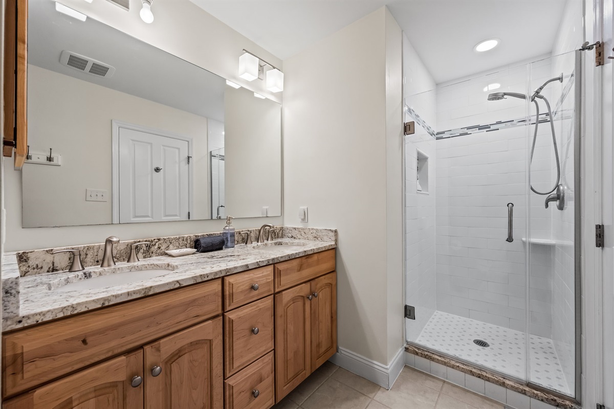 1st-floor kids&rsquo; bathroom with double vanity and walk-in shower