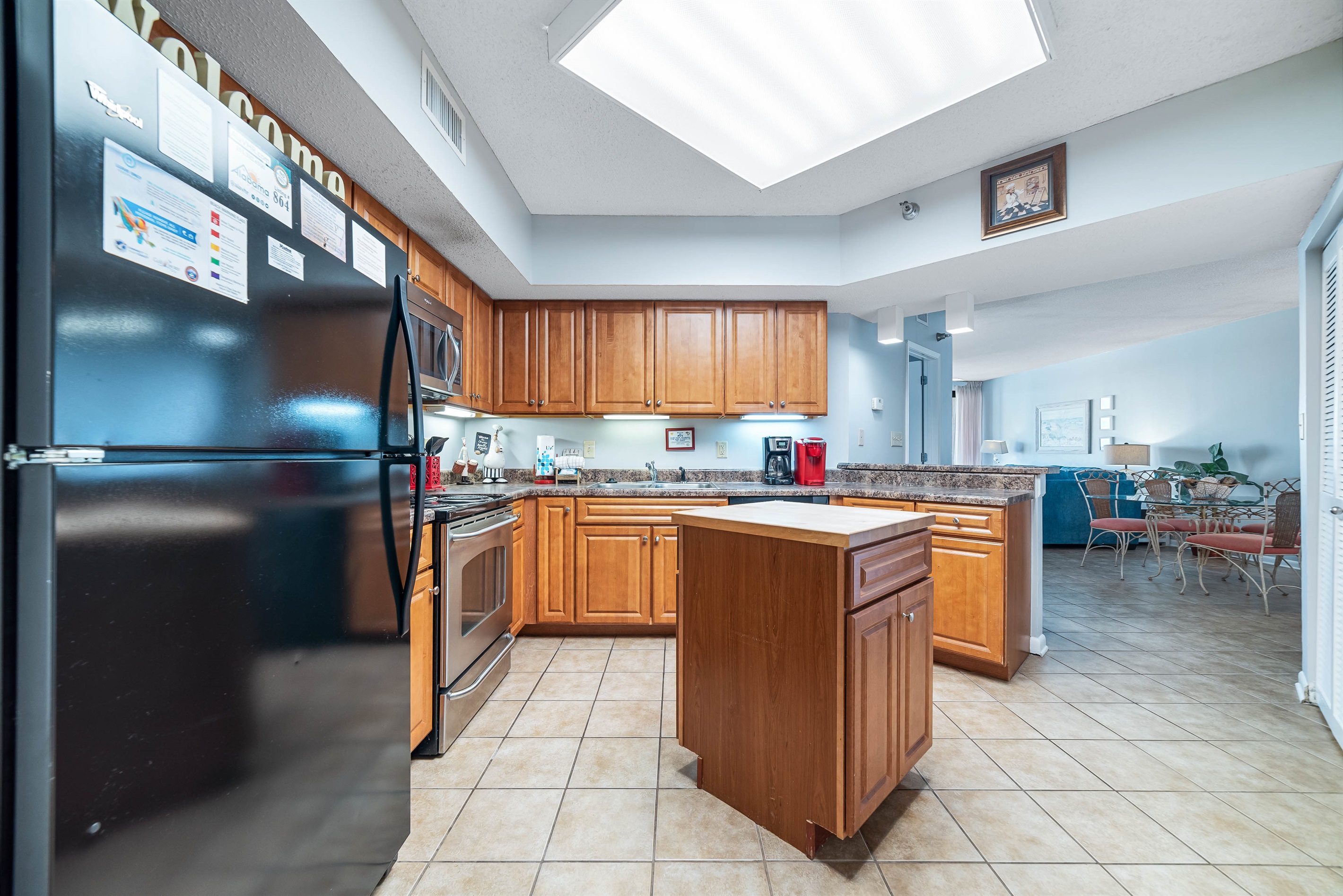 This fully functional kitchen boasts stainless steel appliances, sleek countertops, a decorative backsplash, and ample cabinet storage, ideal for everyday cooking and entertaining.