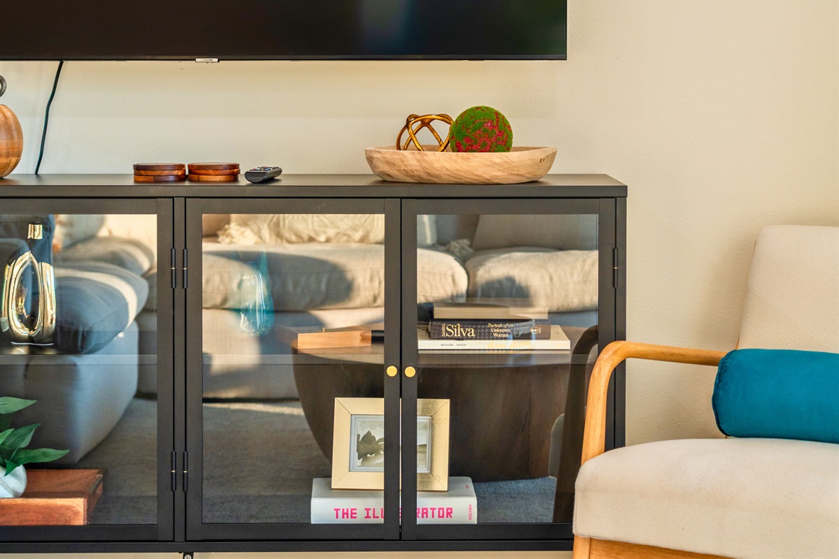 Media console and designer accents bring a touch of sophistication to the living room.