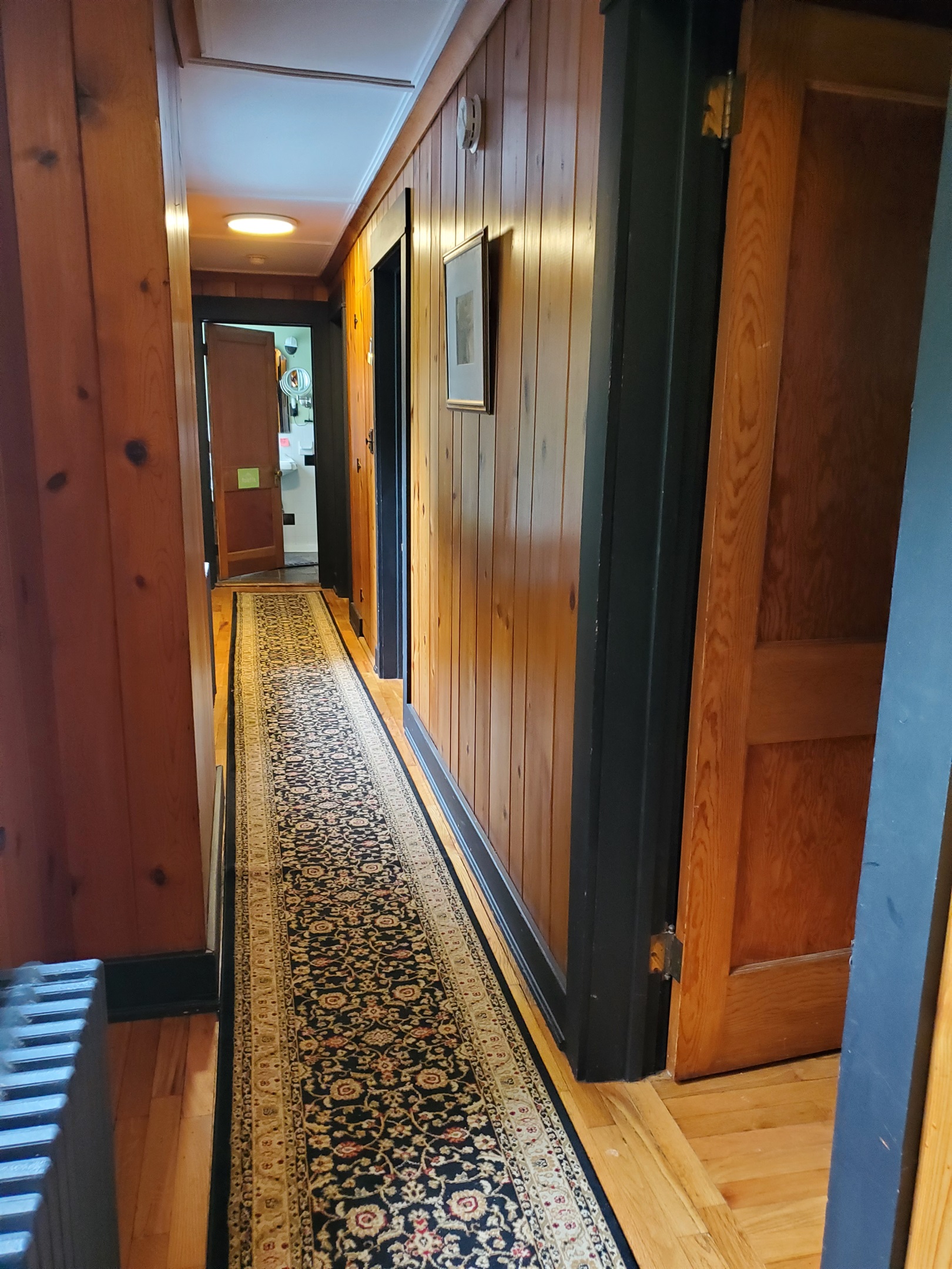 2nd floor hallway w/ doors to each of the three separate 2 bedroom suites