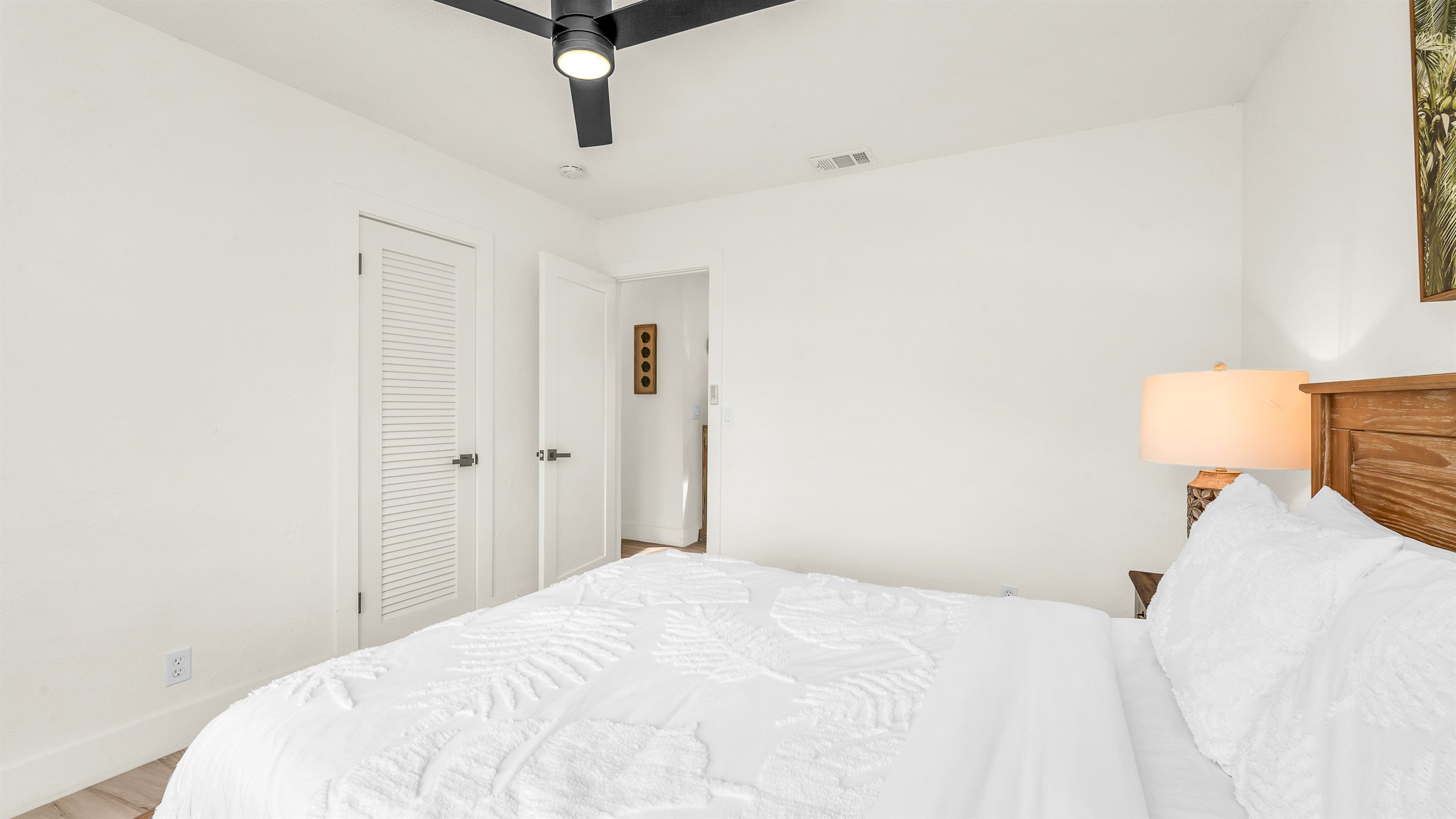 Bedroom 2 offers a relaxing coastal vibe with crisp linens, warm natural light and elegant decor- perfect for guests seeking comfort and tranquility after a day in paradise