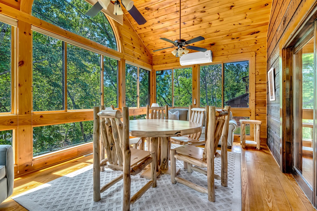 The enclosed sun room overlooking the river below