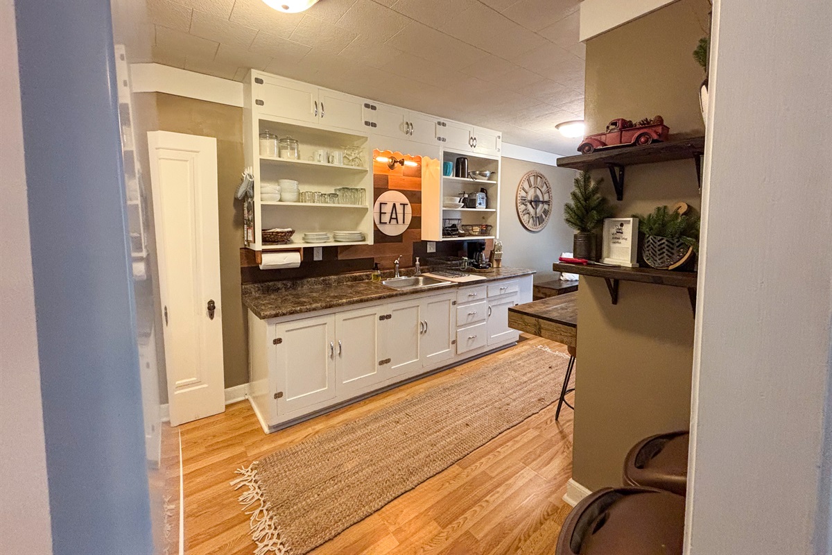 Modern and efficient—everything you need to create a delicious meal. The kitchen features a stainless steel refrigerator, stove, coffee maker, kitchenette oven, kettle, and blender