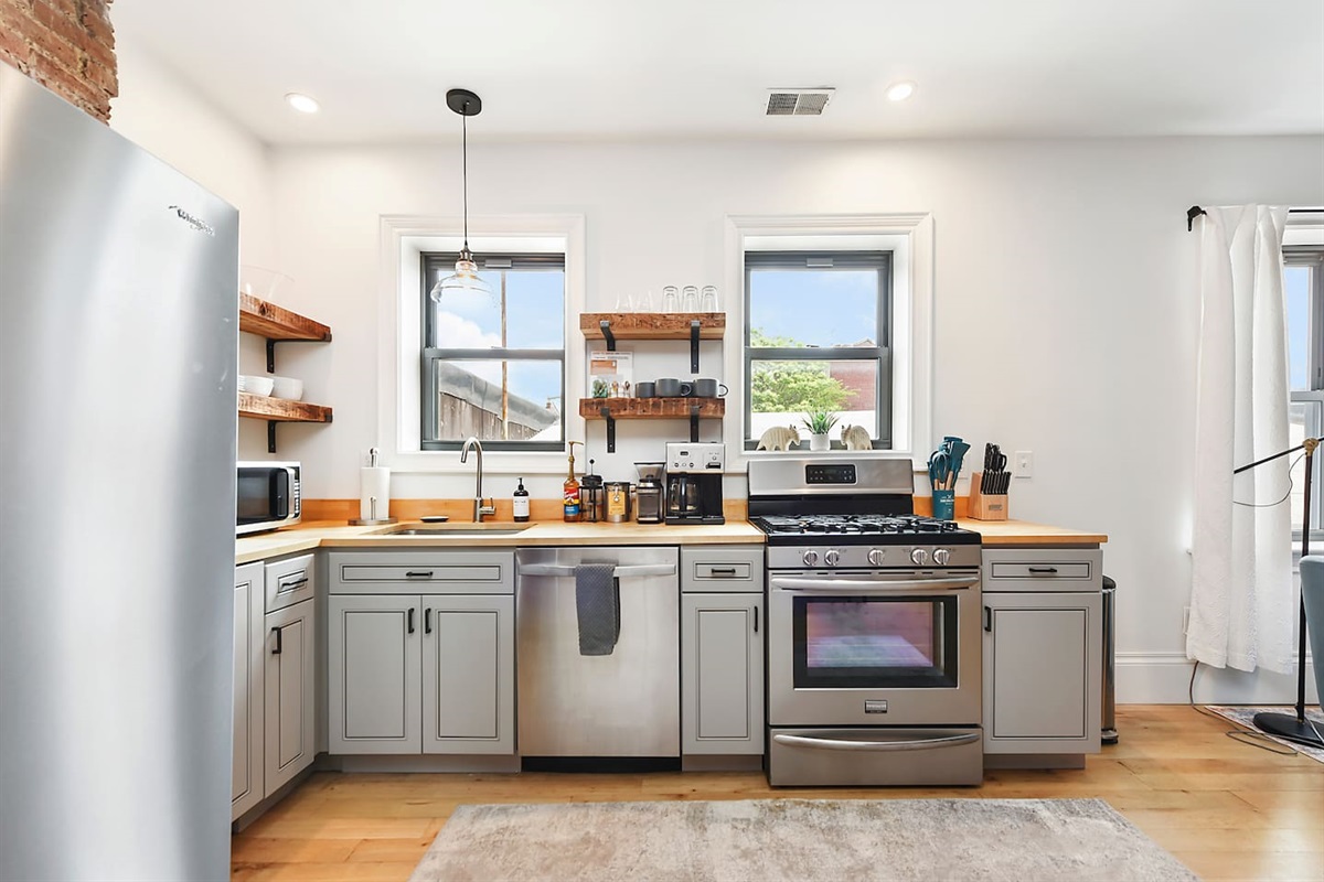 Fully equipped kitchen featuring modern design and sleek stainless steel appliances — ready for all your cooking needs.