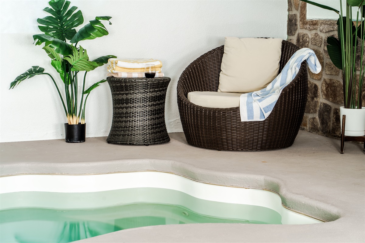 The private indoor pool area features a warm and comfortable couch, creating a welcoming setting for relaxing.