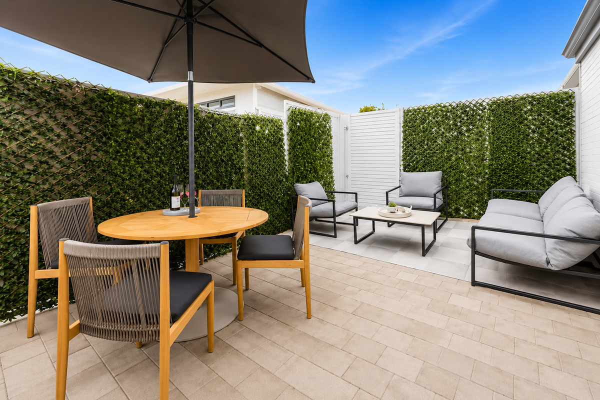 Outdoor dining, lounge chairs and a shaded table give The Duchess of Duke a relaxed courtyard space connected to the home.