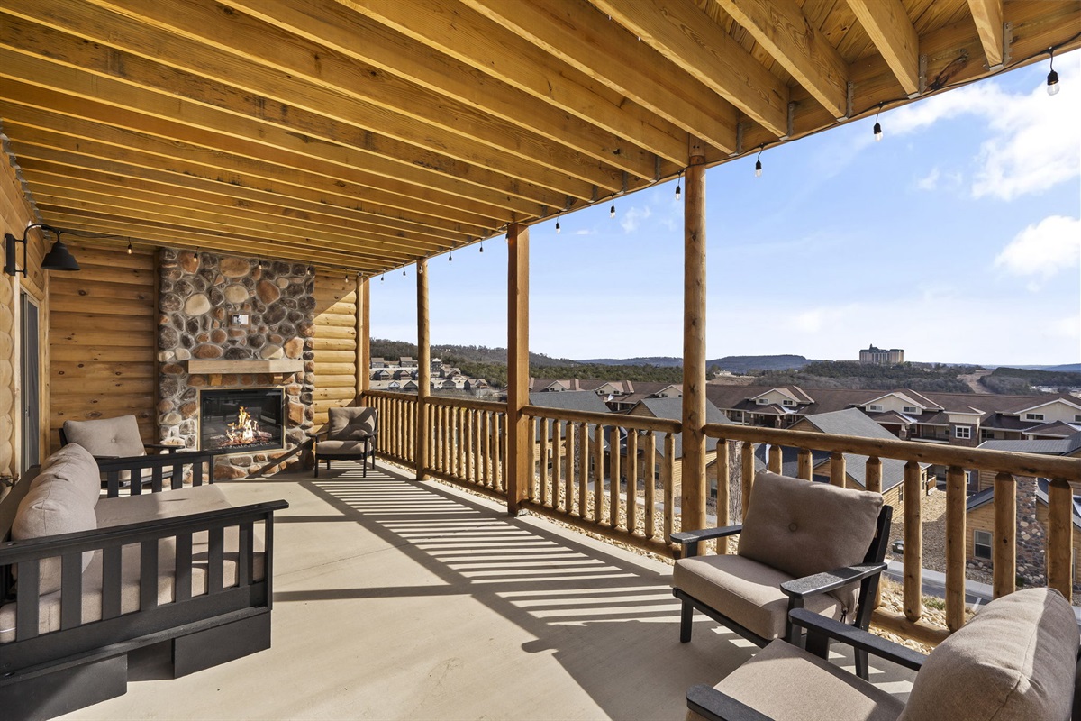 Entry level back patio with electric fireplace and cozy seating