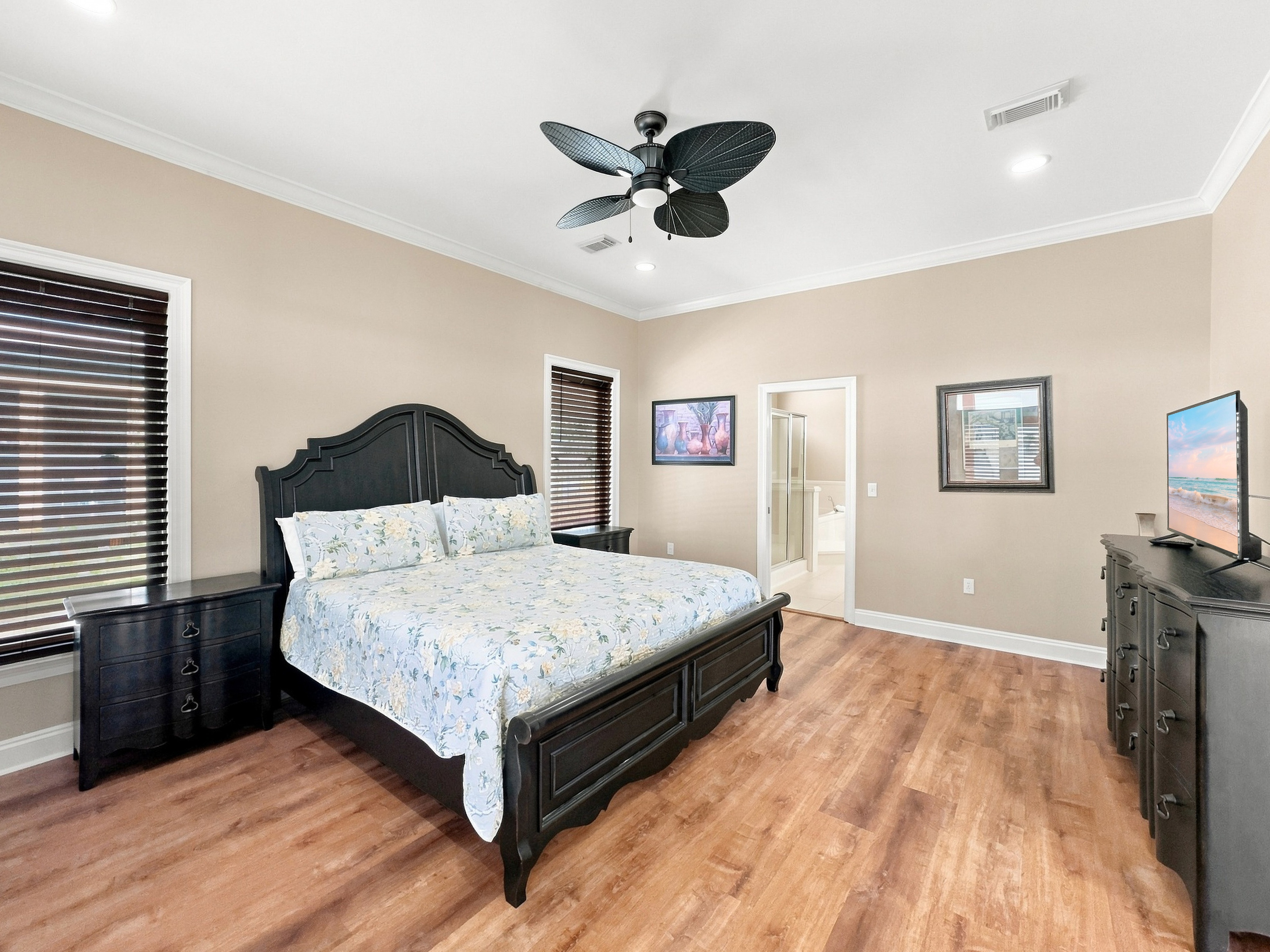 Comfortable bedroom with ceiling fan and coastal styling