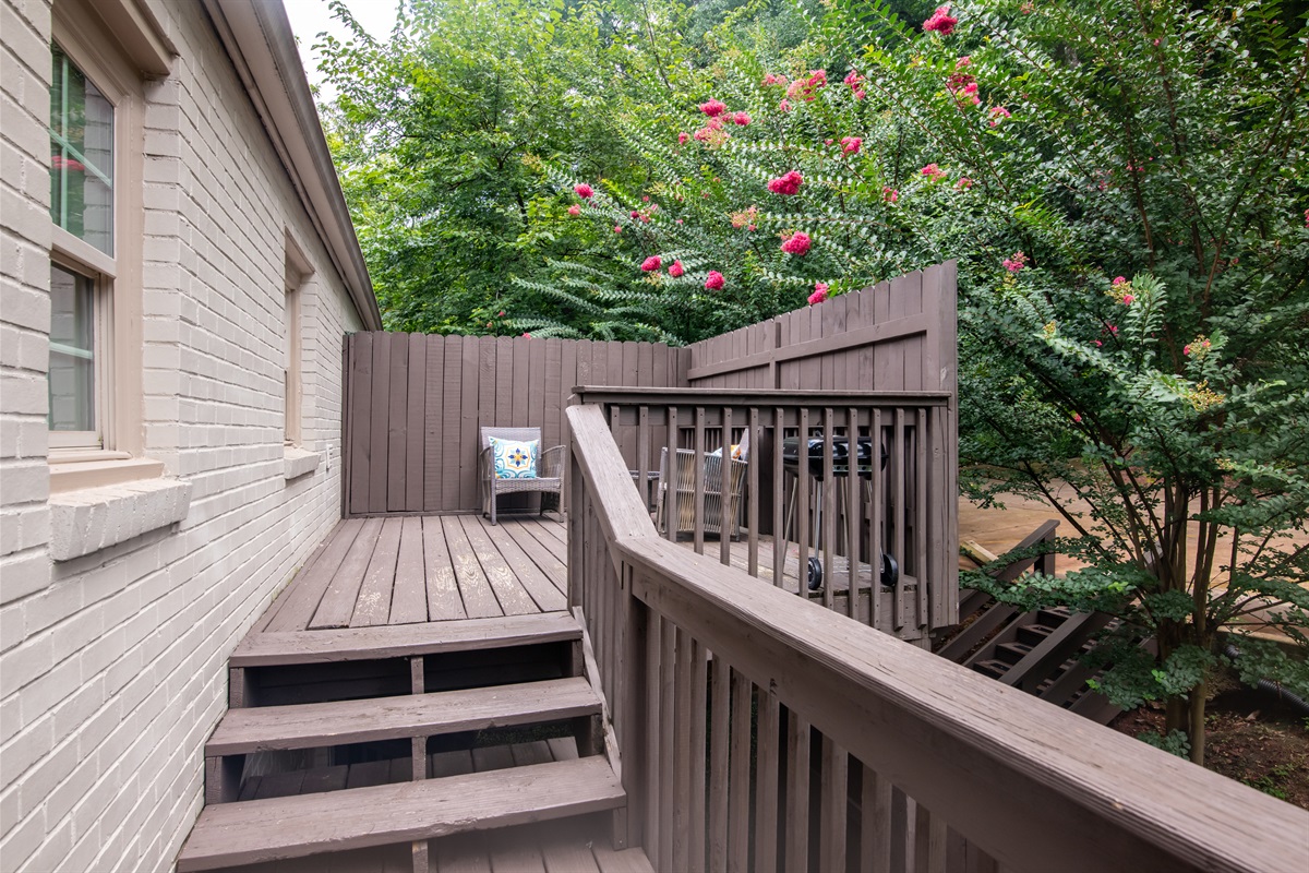 Private side deck with outdoor seating, surrounded by greenery—great for quiet moments.