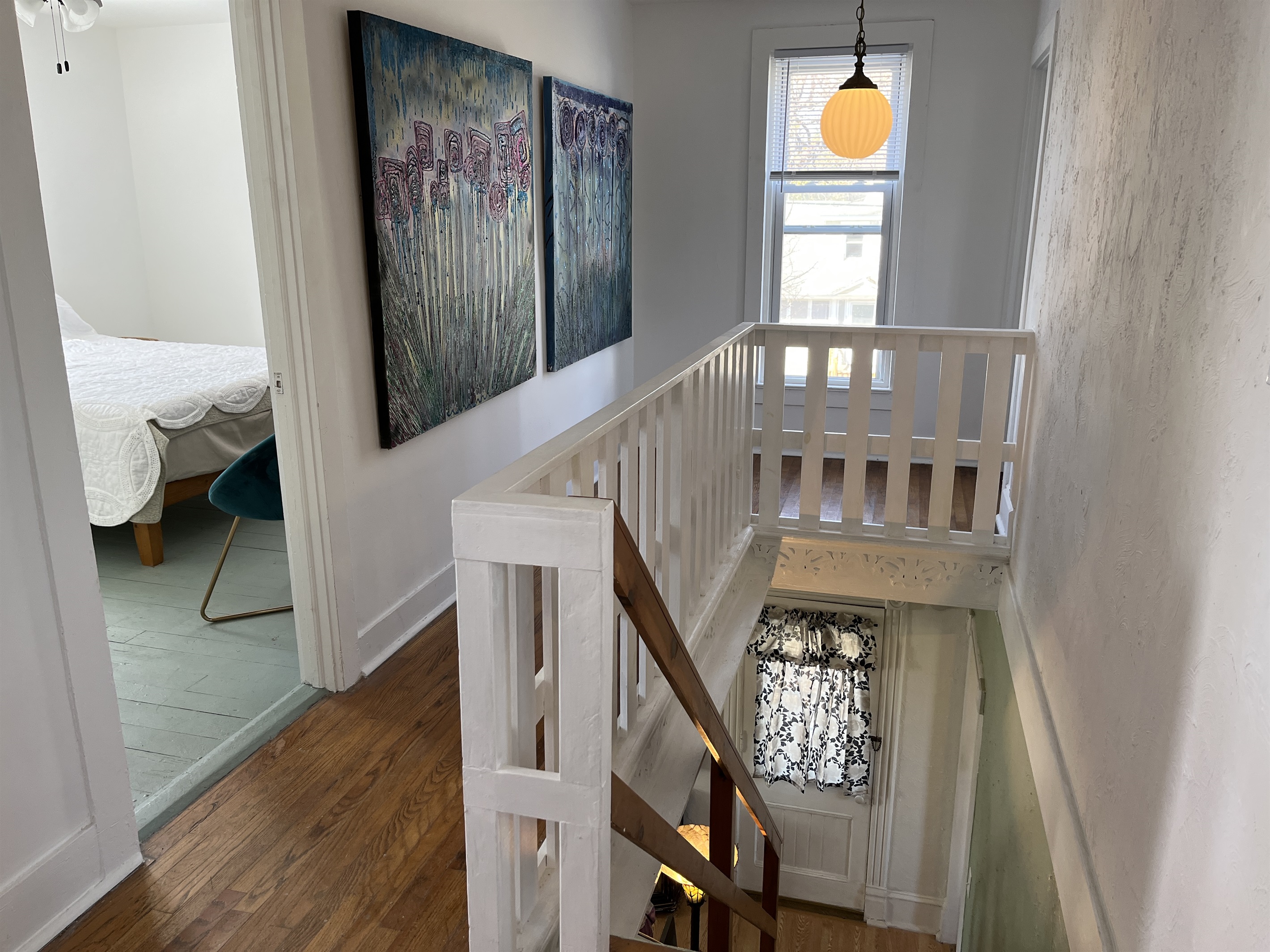 Stairway landing on 2nd floor with original artwork by your host