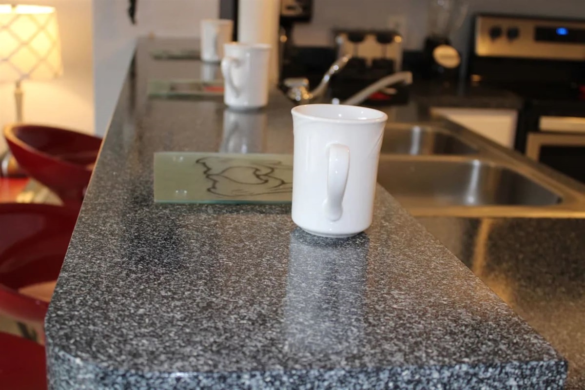 - Breakfast bar with granite countertop and white mugs ready for morning coffee  
- Sleek double sink and modern fixtures for style and convenience  
- Perfect for quick snacks or casual meals while chatting with friends and family