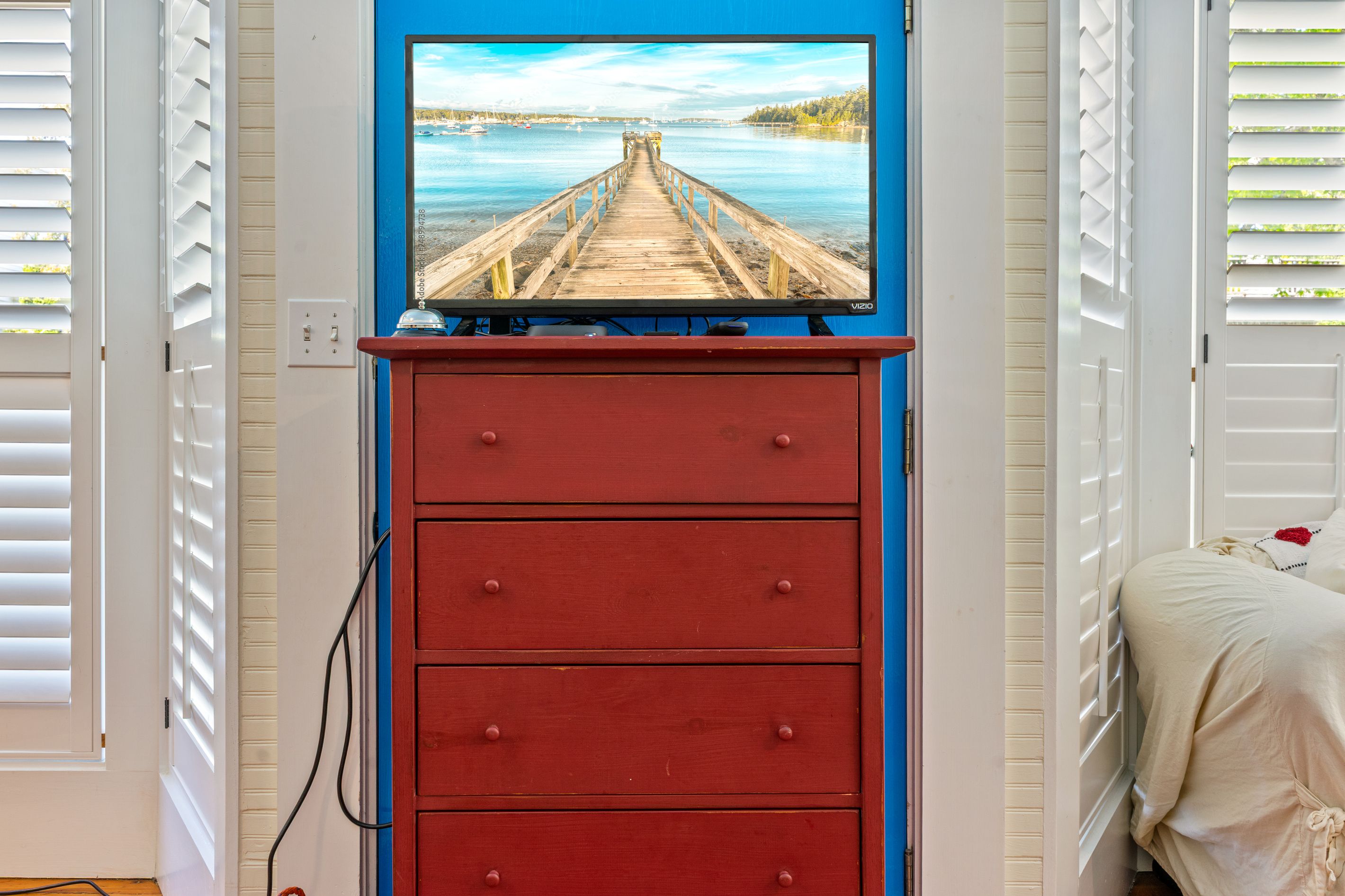 The private theater station inside the "Crew’s Quarters." Positioned on a classic red dresser, this Roku Smart TV provides the little sailors with their own dedicated entertainment zone to stream movies and wind down after a day on the coast.