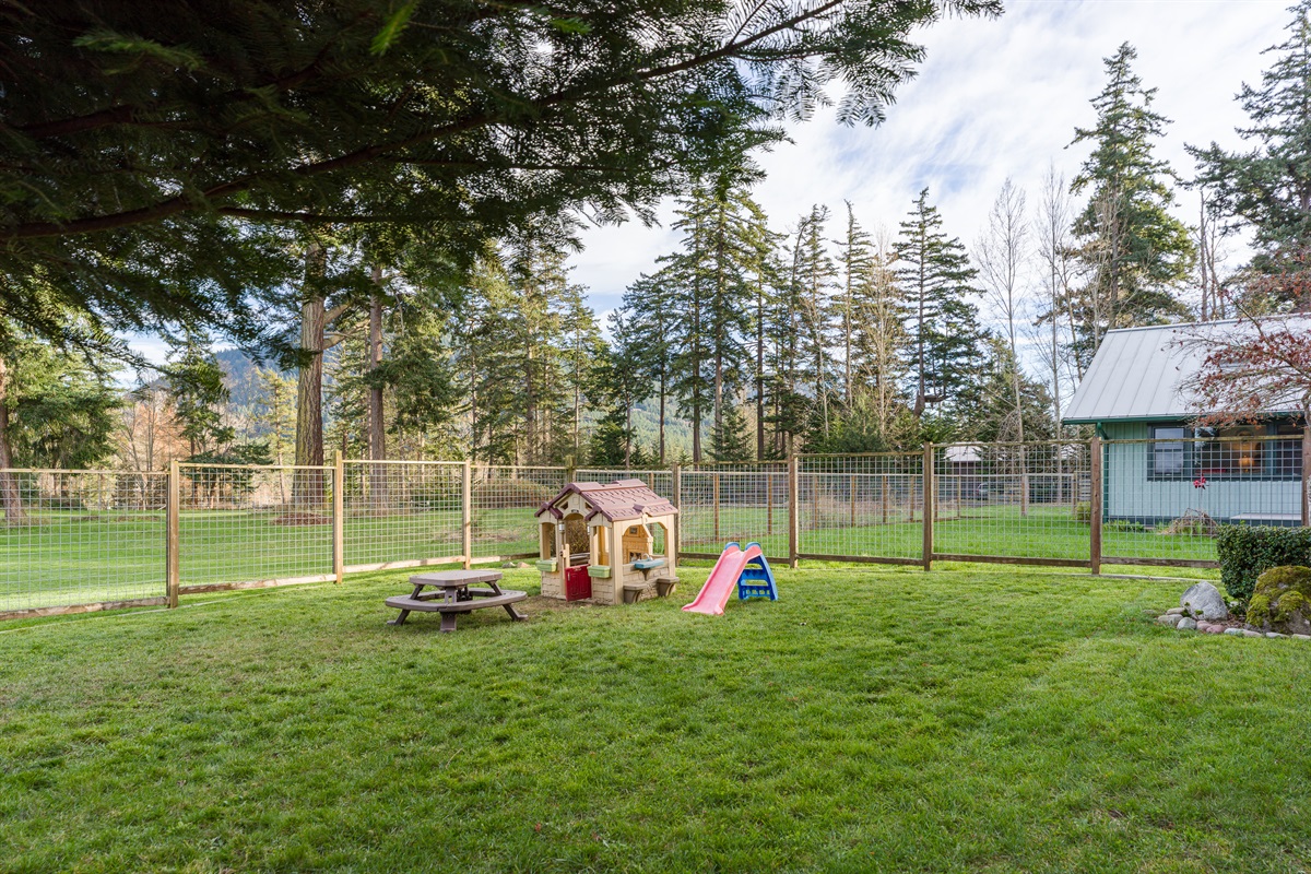 Let their imagination run wild in this outdoor play area complete with playhouse, picnic table and slide.  So much fun for little adventurers.