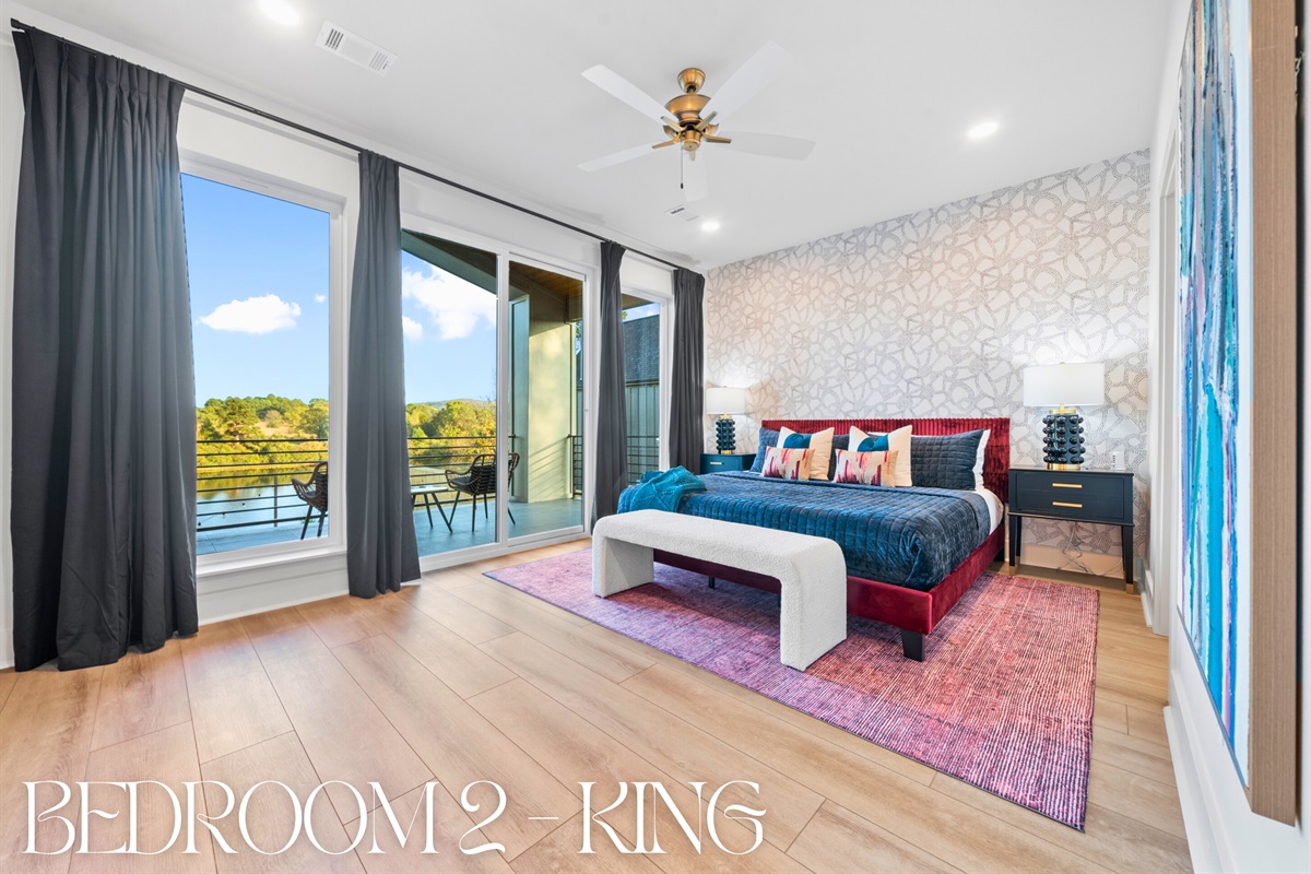 Another cozy king bedroom filled with natural light and one of two with lovely lake views, creating a restful and inviting retreat.