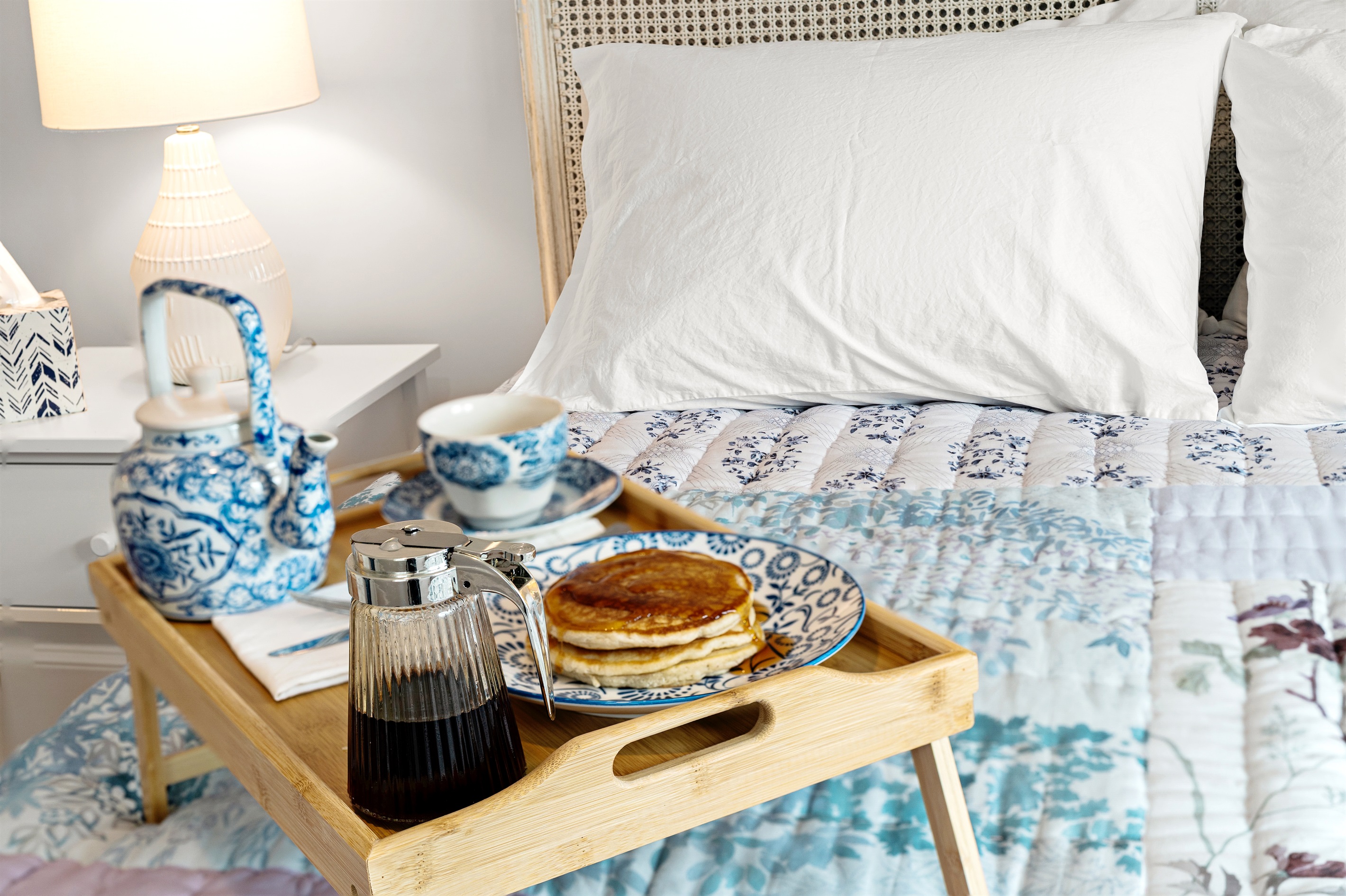 Enjoy natural light and cozy comforts in the first bedroom.