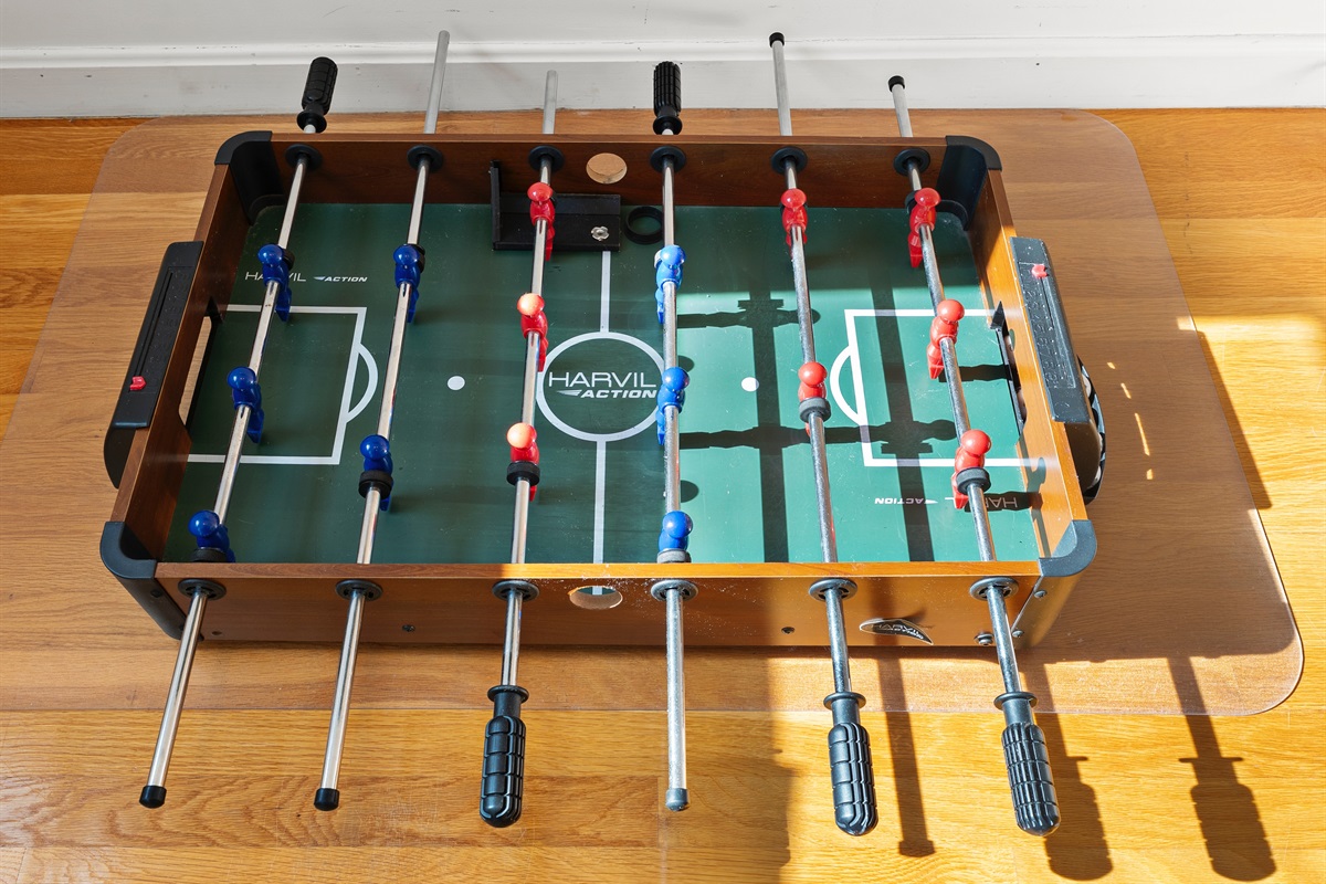 Mini foosball table for endless indoor entertainment.