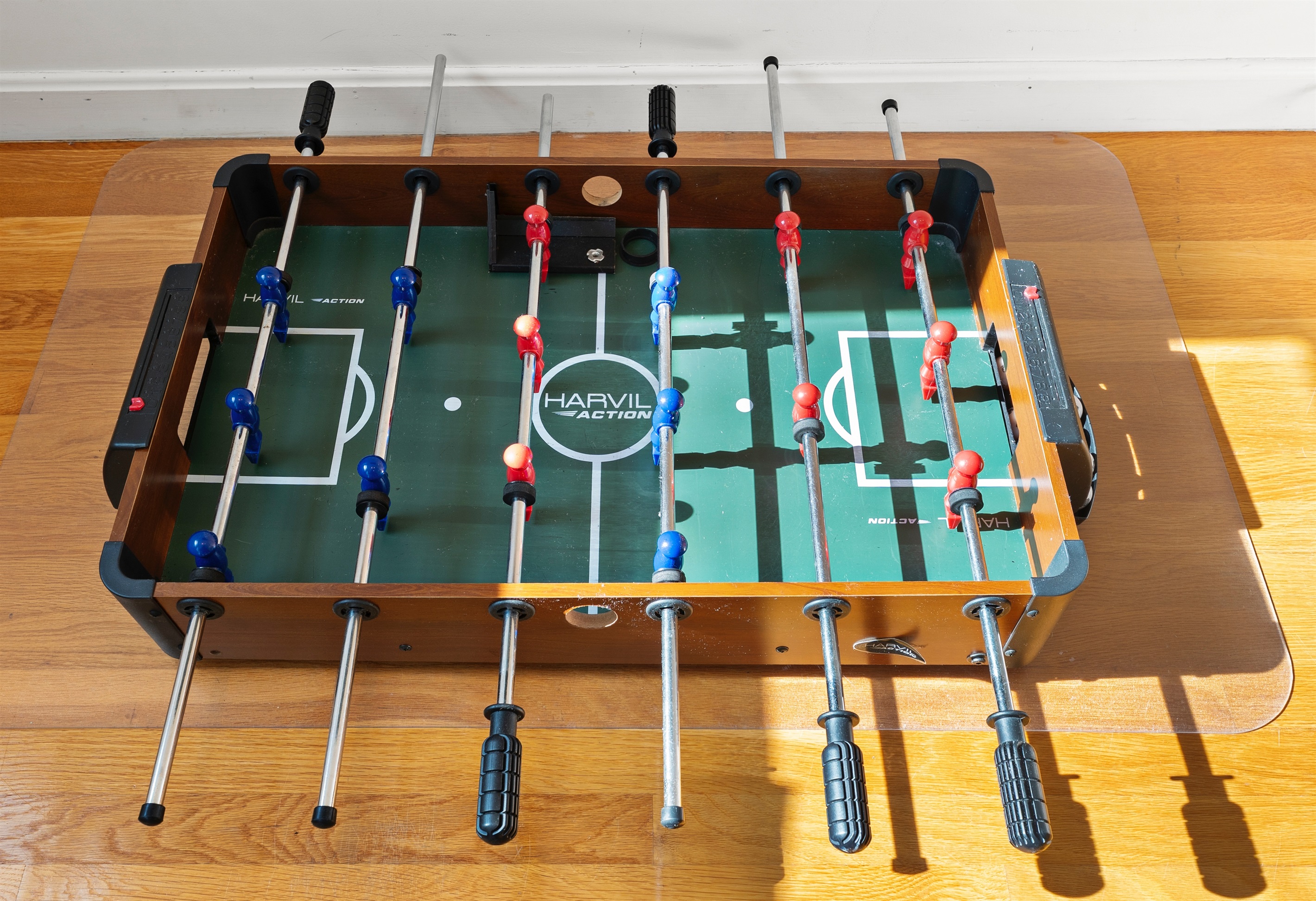 Mini foosball table for endless indoor entertainment.
