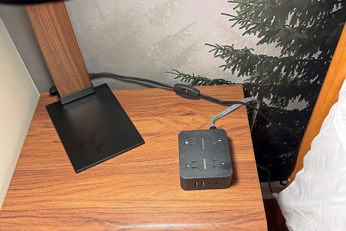 Each side table has a charger and/or device charger included.  Hunting around for available wall outlets is not relaxing so stay at Acorn&Antler and skip that step.