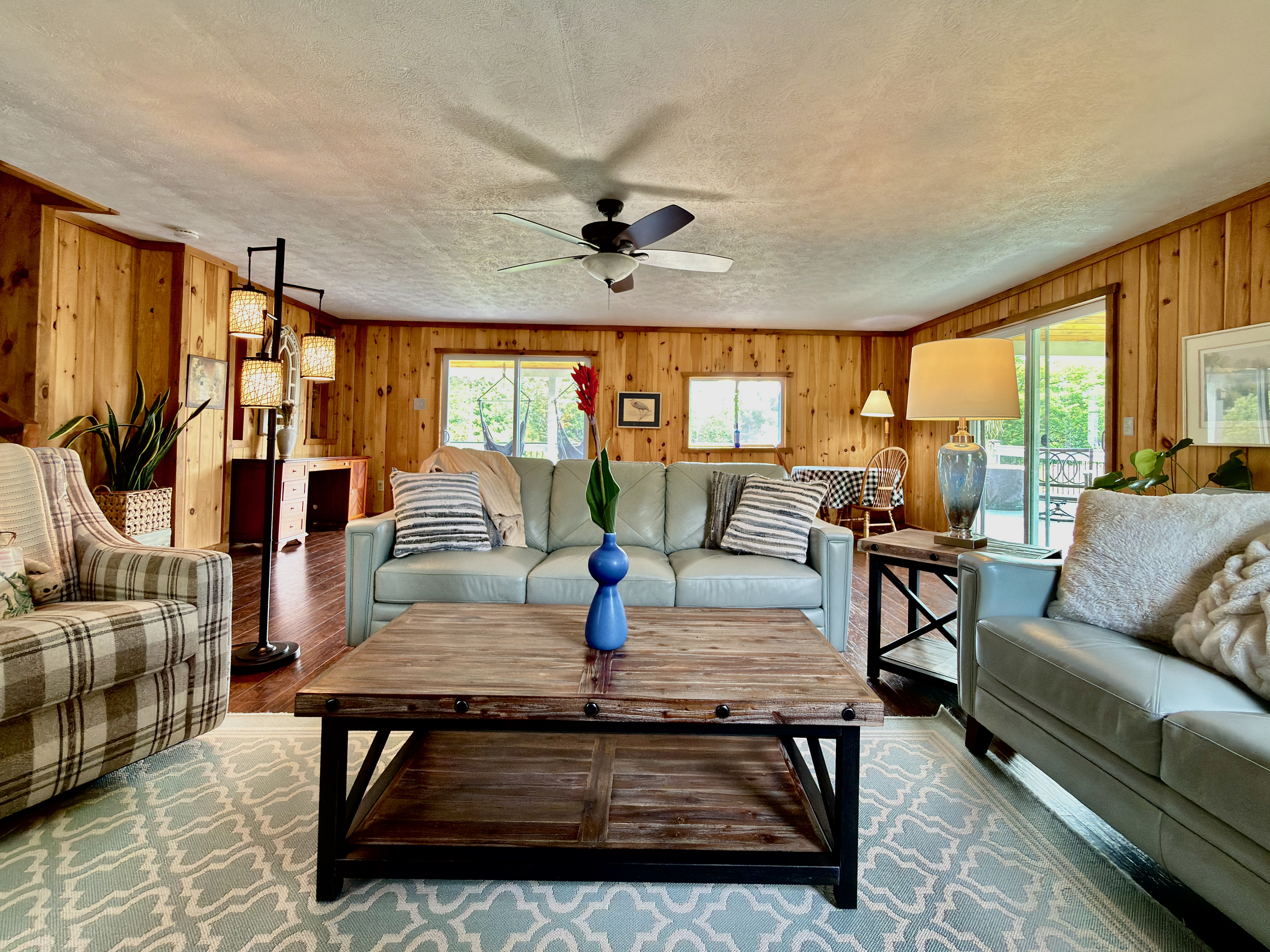 Unwind in our open-concept living room, complete with high-quality leather couches, a TV, and a quiet desk area. Fully climate-controlled for your comfort, this bright space offers seamless indoor-outdoor living with direct deck access. (See notes)
