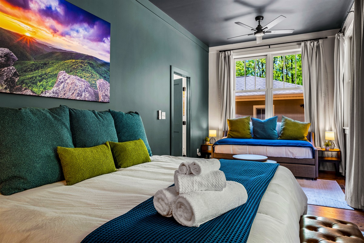 Surround yourself with color, comfort, and calm—this master suite blends luxury linens with local art and modern design for a restful retreat right off the main floor.