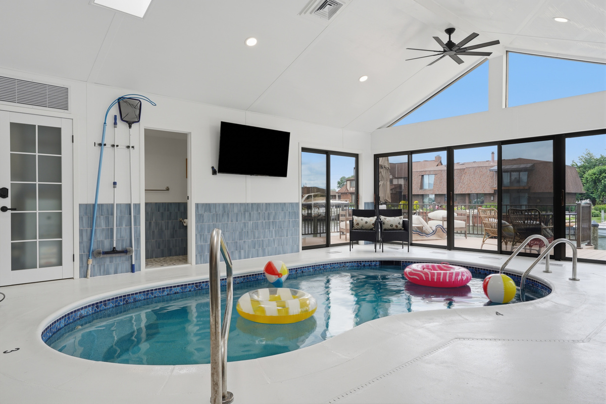 Relax and enjoy year-round swimming in this bright indoor heated pool, featuring vaulted ceilings, skylights, and a spacious open design ideal for both lounging and entertaining.