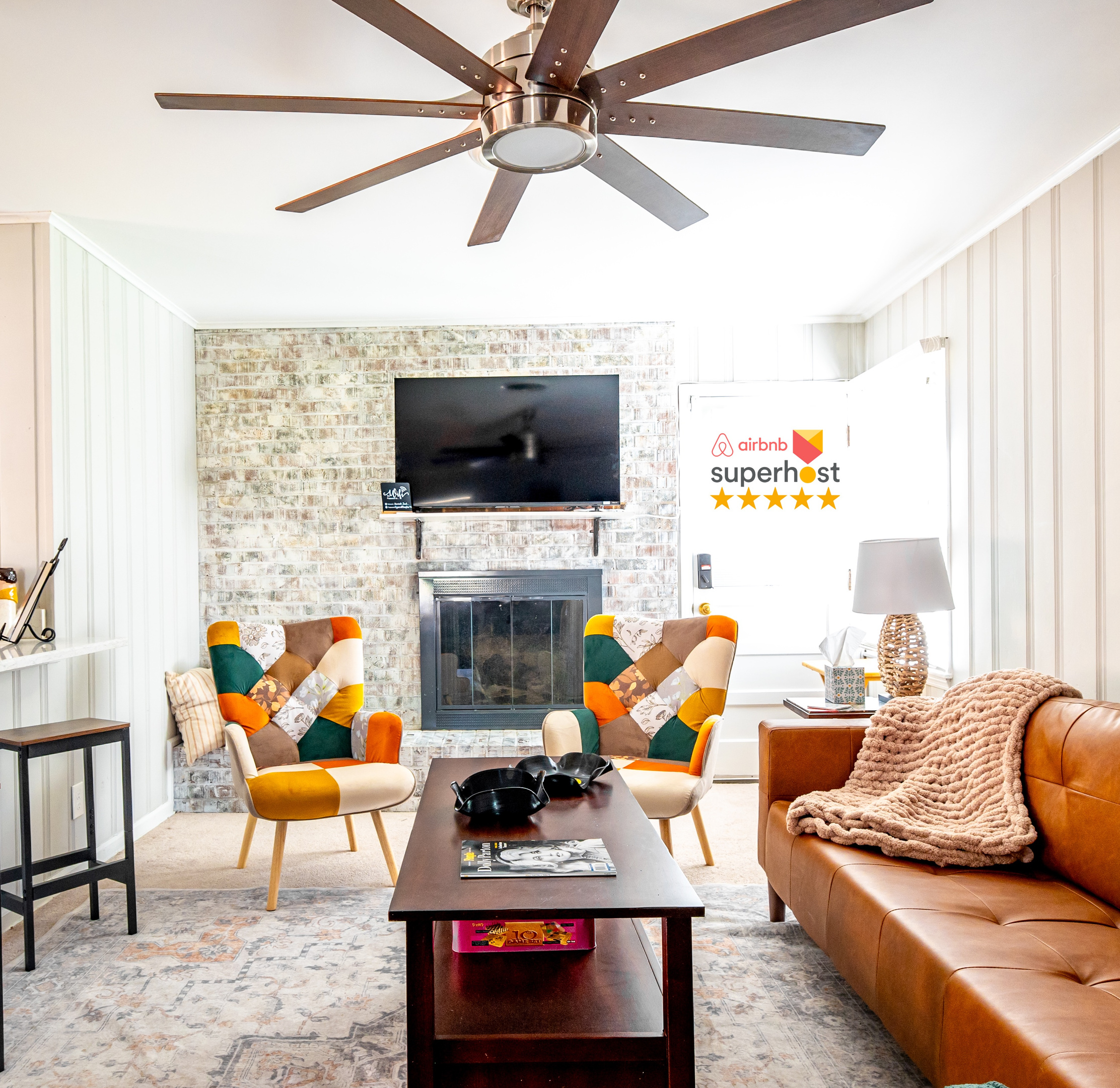 Living room that opens to the kitchen. Plenty of seating, decorative fireplace, TV