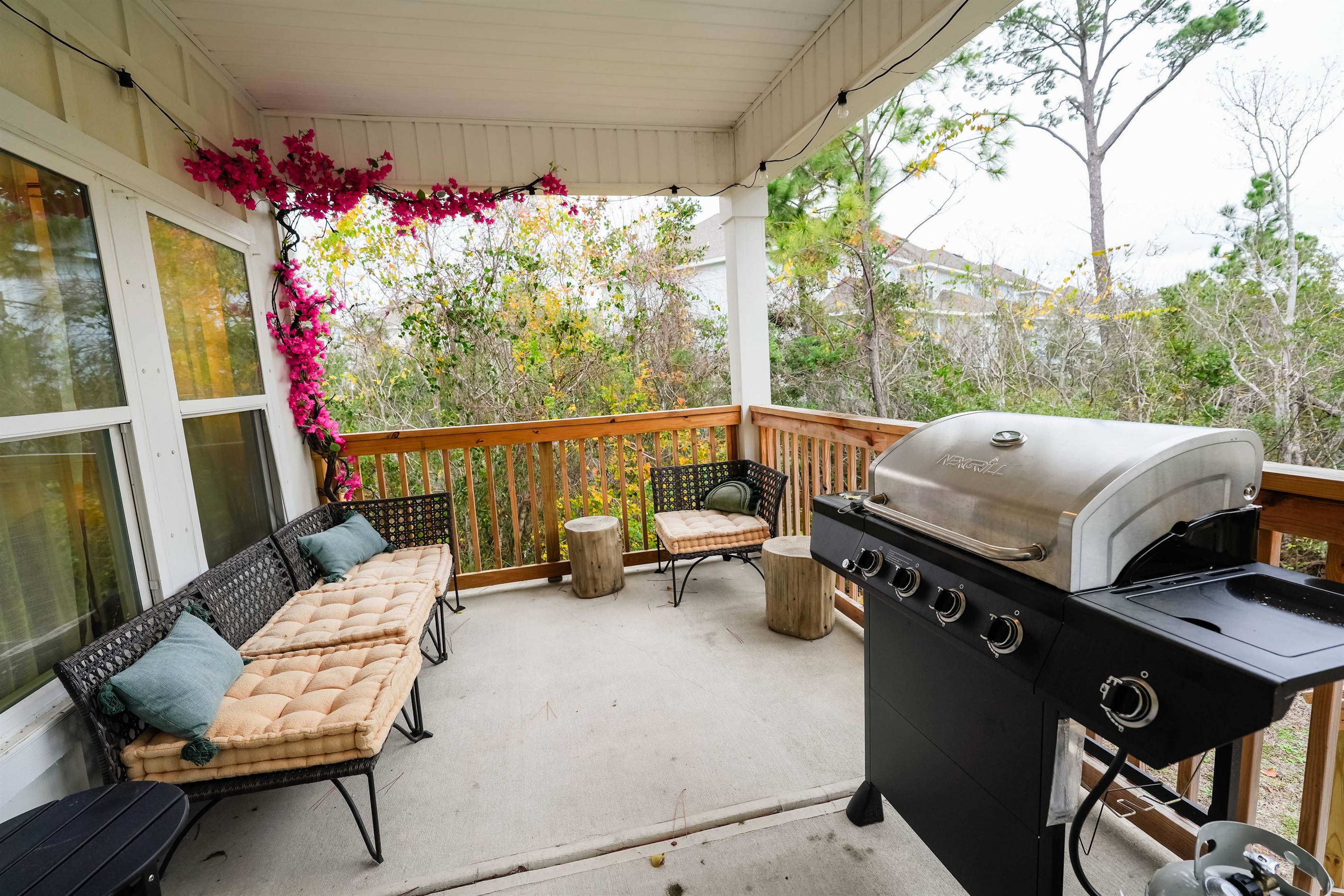 Savor the moments: A perfect blend of comfort and flavor awaits on the inviting porch, complete with cozy seating and a sizzling BBQ.