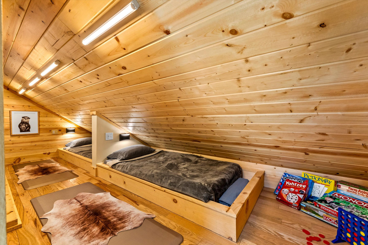 Custom built-in twin beds with individual reading lights, white noise machine and cozy bedding.