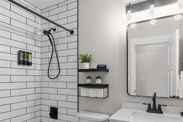 Second floor shared bathroom with shower over tub. Shampoo, conditioner, body wash, hand soaps and hair dryer available for your use.