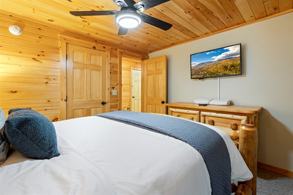 This additional queen room includes a ceiling fan and TV for extra comfort and convenience.
